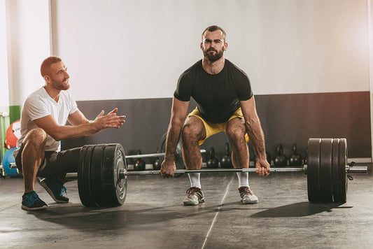 Man training with barbell and bumper plates