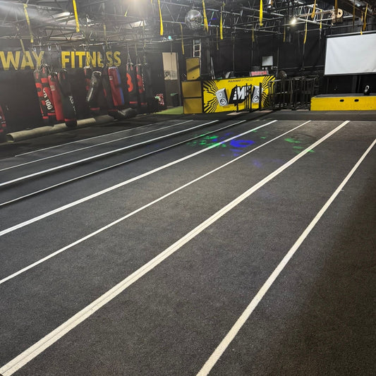 Grey with laned tracks laid isie by side in gym