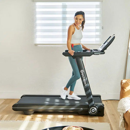 Female resting on treadmill in a living room with soft lighting