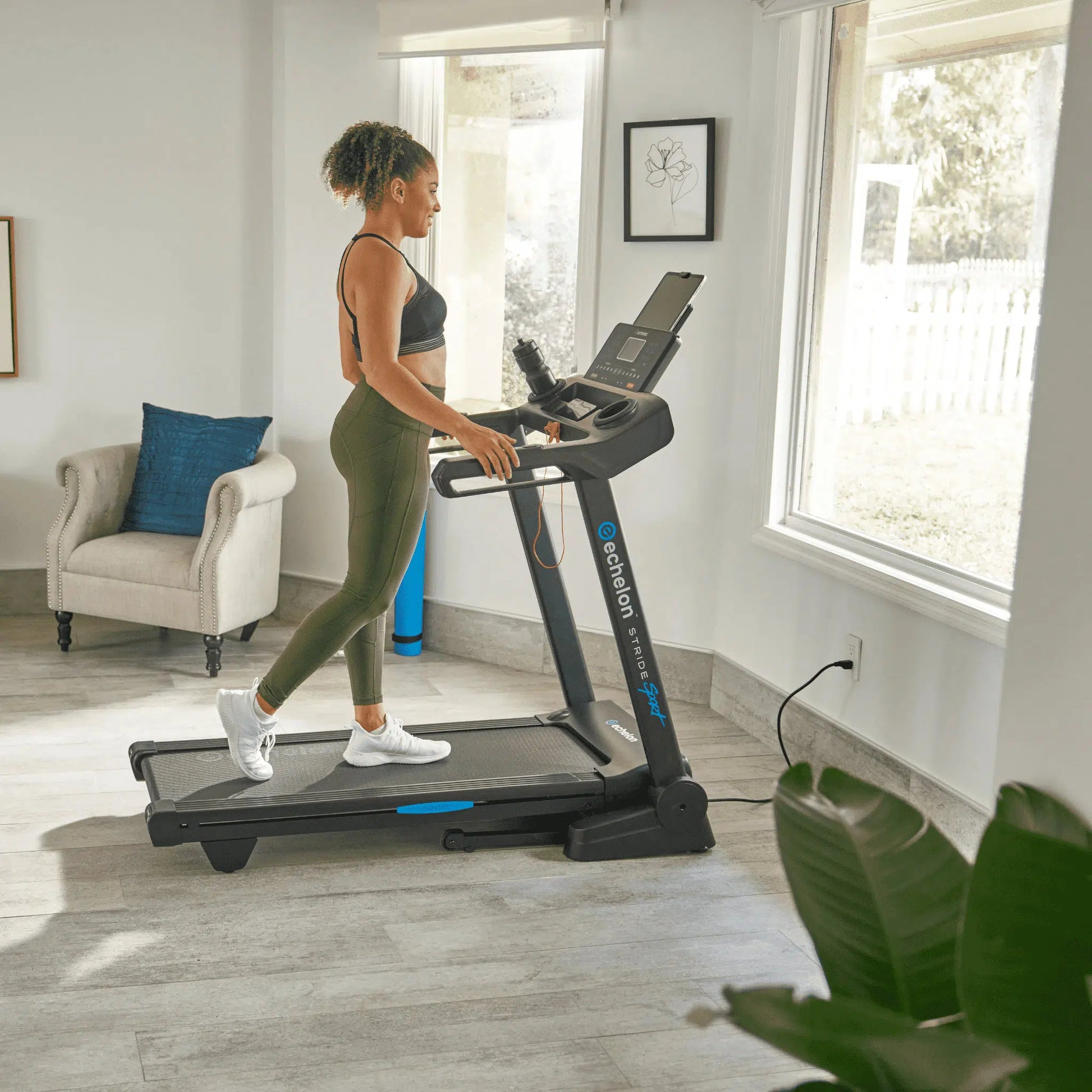 girl on stride 20 treadmill in home with large windows and soft lighting