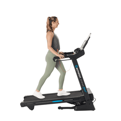 Photo of a women on stride 20 treadmill in the incline position on a whiite background